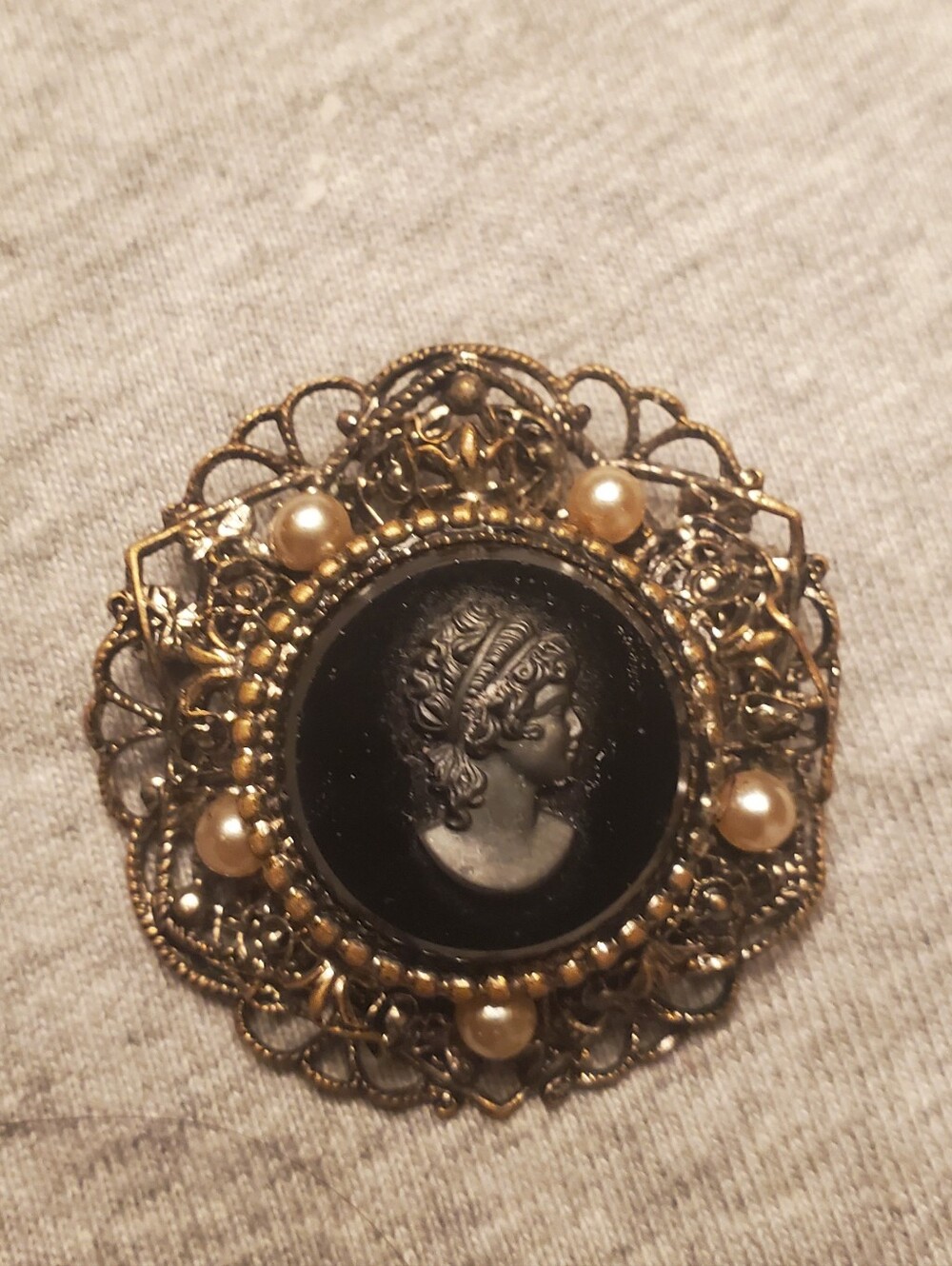 Vintage-Inspired Gold Cameo Brooch with Black and Pearl Accents
